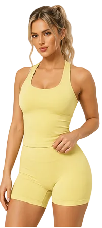 A woman modeling a pale yellow athletic tank top and matching high-waisted biker shorts against a light beige studio background.