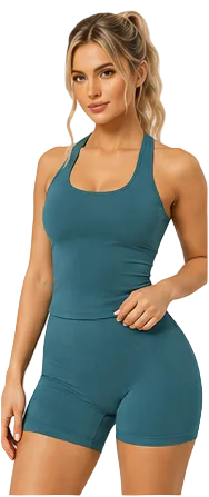 A woman modeling a teal blue athletic tank top and matching high-waisted shorts against a light beige studio background.