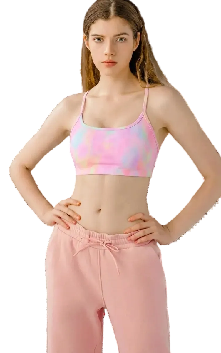 Woman wearing a colorful sports bra and pink pants on a transparent background