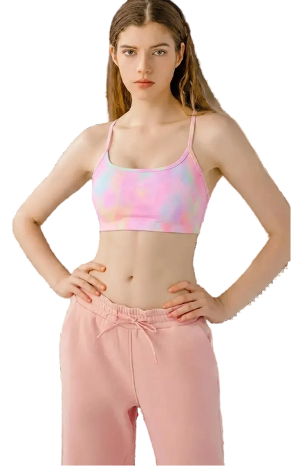 Woman wearing a colorful sports bra and pink pants on a transparent background